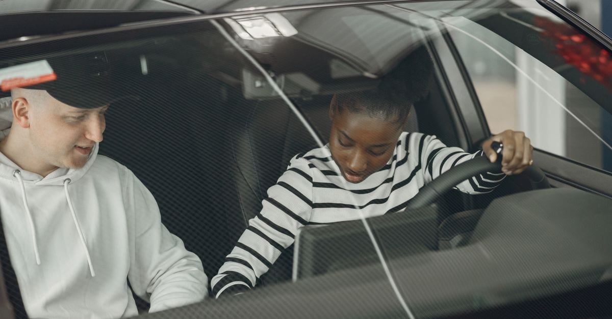 Driving instructor reviewing student performance notes after a mock test