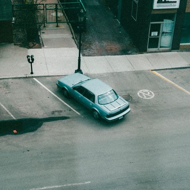 Student practising parking in an automatic car on a quiet suburban street
