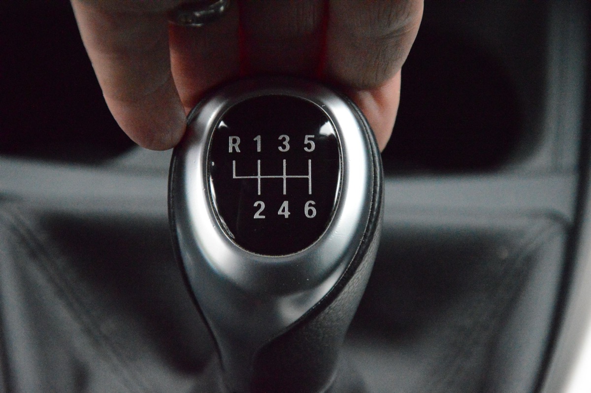 A hand on a manual gear stick